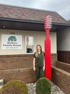 dental associate with oversized toothbrush