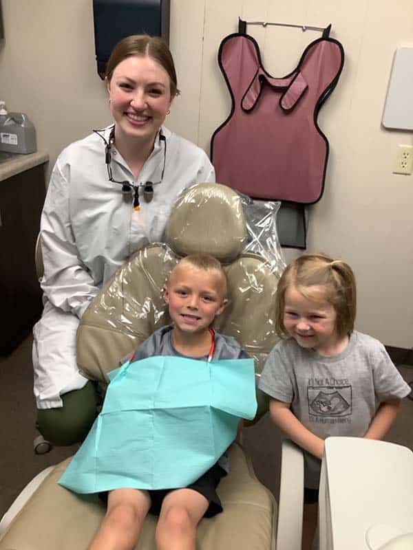 Rachel Salen, D.D.S. with two young smiling patients